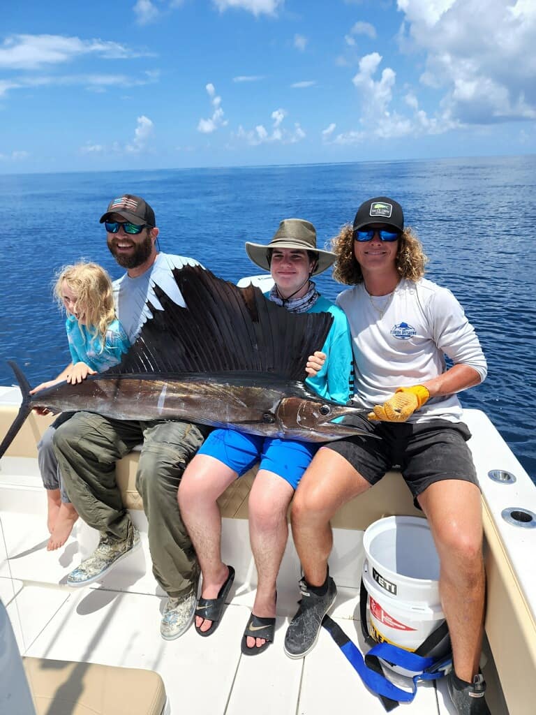 Family displaying catch on boat